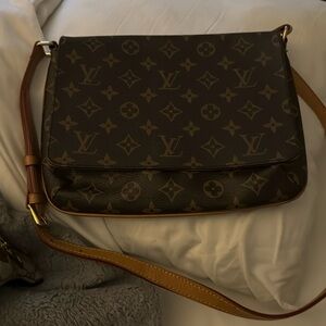 Louis Vuitton cross body bag used but in good condition for how old it is.